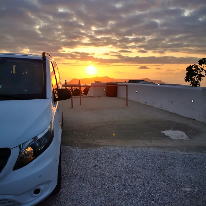 The VH Transfer Mercedes Vito parked at a Santorini caldera viewpoint at sunset